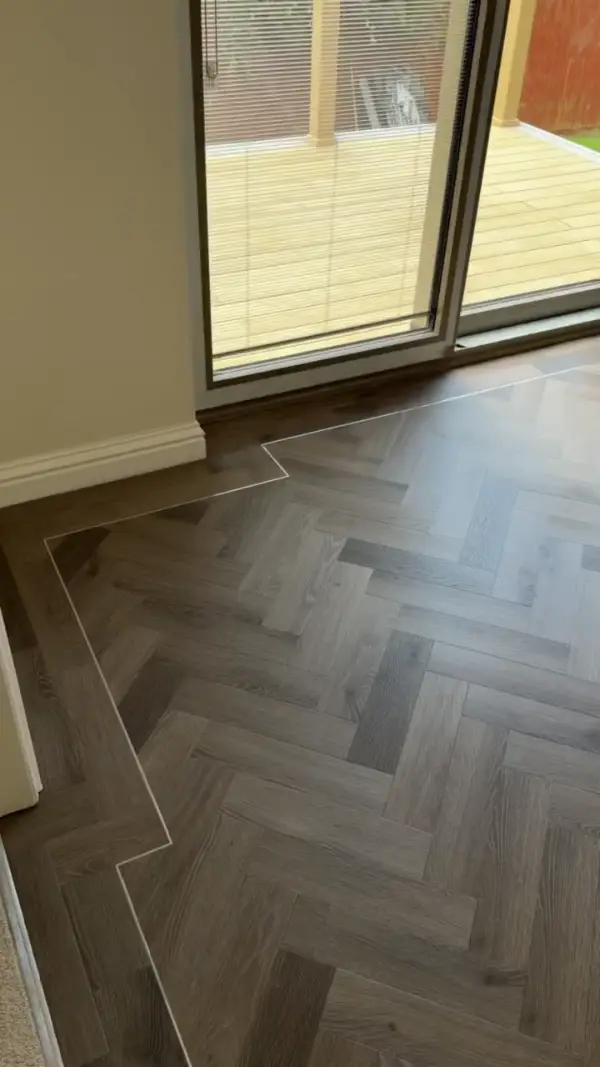 Walkthrough of a smoked grey oak herringbone dining room, with a perimeter border and fine strip following the patio doors